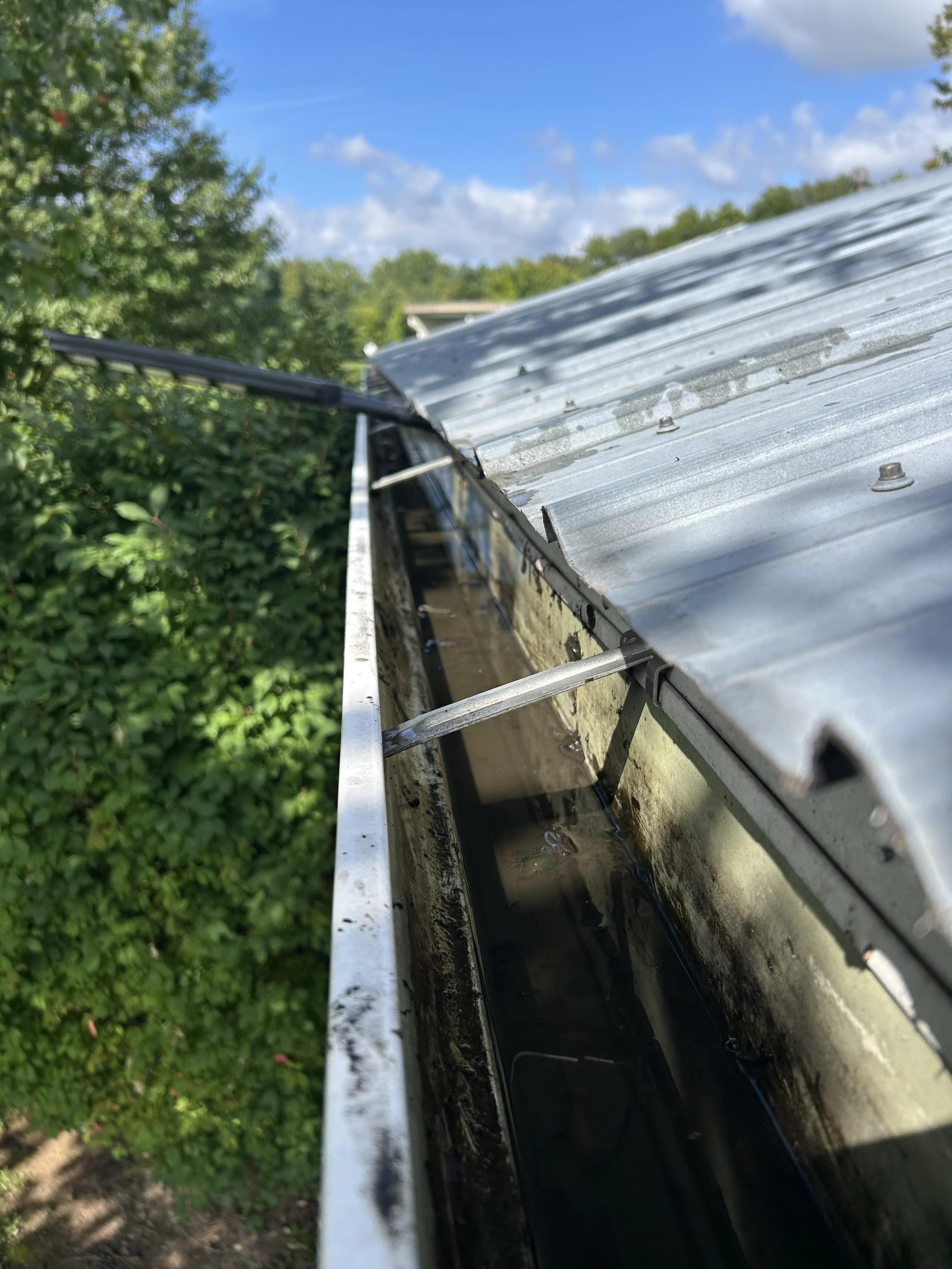Cleared commercial roof gutter and drain channel after cleaning by YZ Construction