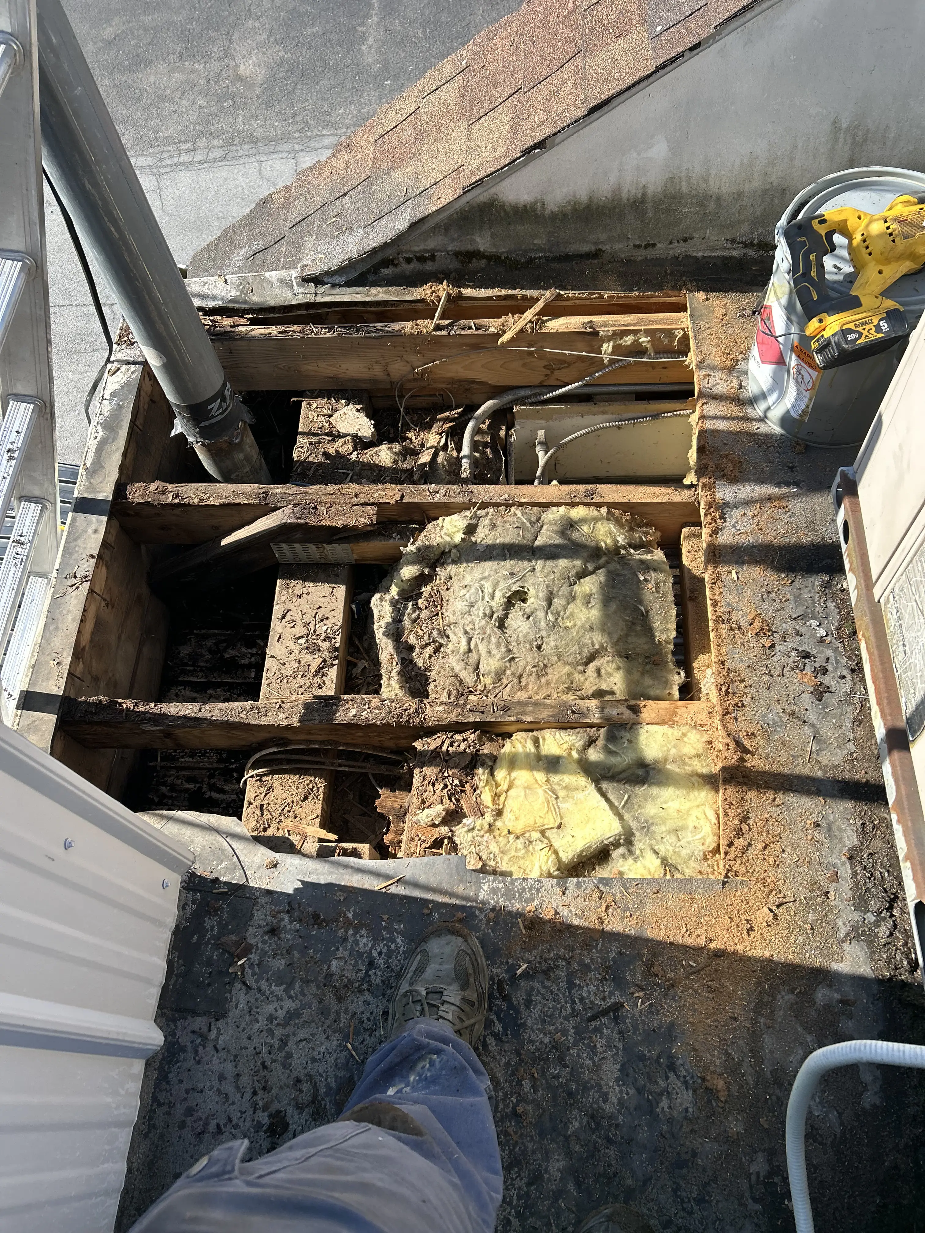 Worn commercial flat roof in Pennsylvania before restoration — visible membrane wear and drainage issues